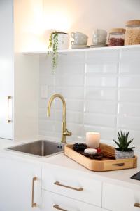 a kitchen counter with a sink and a cutting board at River View Escape close to Mount Maunganui & shops in Tauranga