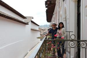 a man and a woman standing on a balcony at Friends Hotel & Rooftop in Quito