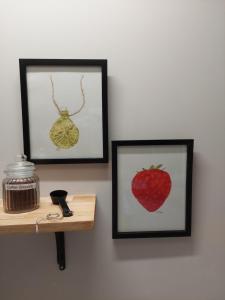 two framed pictures of a strawberry on a wall at The Grey Studio@13a in Carterton