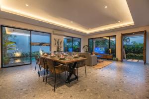 a dining room with a large table and chairs at Villa Daun 3 Canggu by Premier Hospitality Asia in Dalung
