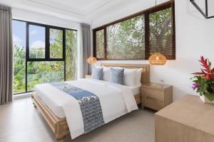 Ein Bett oder Betten in einem Zimmer der Unterkunft Villa Daun 3 Canggu by Premier Hospitality Asia