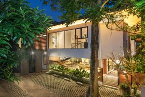 a house with a view of the backyard at Villa Daun 3 Canggu by Premier Hospitality Asia in Dalung