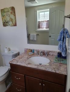 a bathroom with a sink and a toilet at Moody's Motel and Cottages in Wells