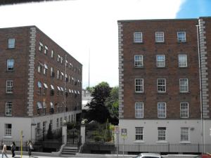 two tall brick buildings with people walking in front of them at Abbott Lodge in Dublin