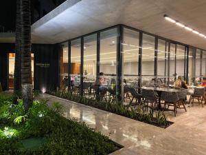 a restaurant with tables and chairs in a building at Flat em Salinópolis no Salinas Premium Resort in Salinópolis