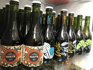 a group of bottles of beer on a shelf at Hostal Piolet en Baños Morales in San José de Maipo