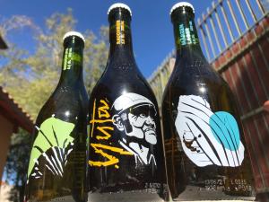 three bottles of wine sitting next to each other at Hostal Piolet en Baños Morales in San José de Maipo