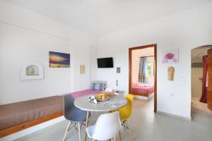 a room with a bed and a table and chairs at Air Brand New Bedrooms in Hersonissos
