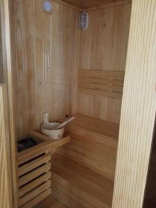 a sauna with a toilet in a wooden room at Khách sạn Hưng Việt (Măng Đen) in Kon Tum +17 photos