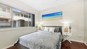 a bedroom with a bed and a window at Avani - Modern & Tranquil - Wifi in Booker Bay