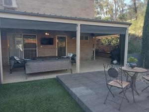 a patio area with a patio table and chairs at Riesling Trail & Clare Valley Cottages in Clare