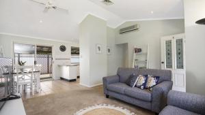 a living room with a couch and a table at Beach Daze - Umina Beach Family Friendly in Umina