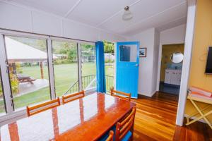 a living room with a blue door and a balcony at Kooyong Apartment 3 in Arcadia