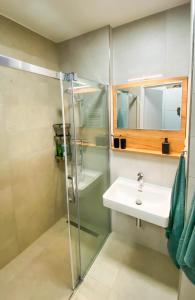 a bathroom with a shower and a sink at Apartmán LUMI Zadov in Stachy