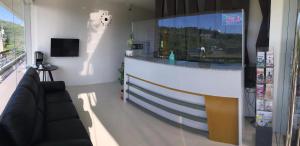 a living room with a bar in the middle of a room at NutriTECH Hotels & Events in Calapan +18 photos