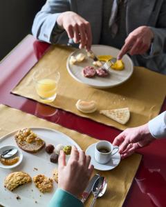 a group of people sitting at a table eating breakfast at Executive Spa Hotel in Fiorano Modenese