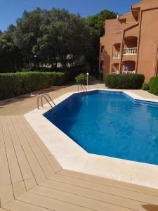 a large blue swimming pool next to a building at Sommer, Sonne, Strand und Pool! in Canyamel