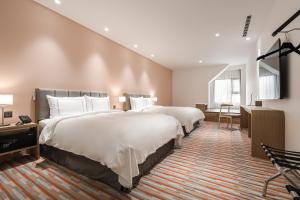 Postel nebo postele na pokoji v ubytování Phoenix Hotel Taichung
