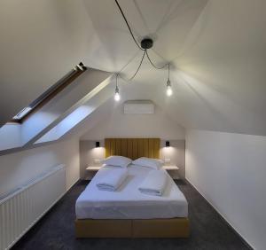 a bedroom with a large bed in a attic at XO Residence in Arad +42 photos