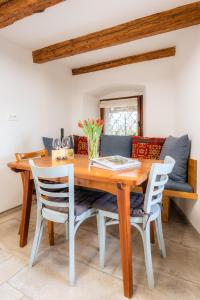 a dining room with a wooden table and chairs at Apartment VILLA IRENA Great For a Family Holiday With Free Parking And EV Station in Ajdovščina