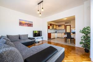 a living room with a couch and a kitchen at Apartment Marija in Novigrad Dalmatia
