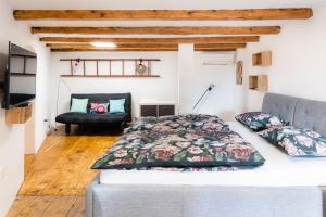a bedroom with a bed and a chair at Apartment VILLA IRENA Great For a Family Holiday With Free Parking And EV Station in Ajdovščina