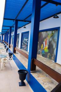 a row of tables and chairs on a building with paintings at Aqaba Adventure Divers Resort & Dive Center in Aqaba