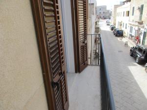 an open door on a building with a street at Le Case Di Tufo- Casa del sole in Favignana