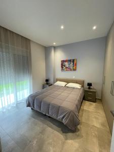 um quarto com uma cama e um quadro na parede em Olive Tree Garden em Cidade de Kos