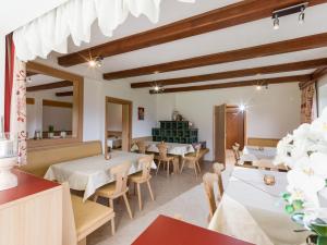 a restaurant with tables and chairs in a room at Pension Leamhof in Hopfgarten im Brixental