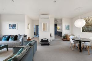 a living room with a couch and a table at APARTMENT 4A - By the Beach in Paraparaumu Beach