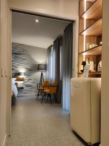 a room with a refrigerator and a bedroom at Hotel Stella Del Mare in Chiavari