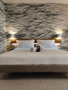 a bedroom with a large bed with a wall at Hotel Stella Del Mare in Chiavari