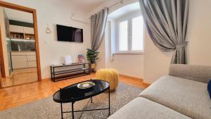 a living room with a couch and a table at Etal Luxury Apartment in Dubrovnik