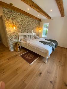 een slaapkamer met een bed en een houten vloer bij Historical Villa in the heart of Bled 2 in Bled