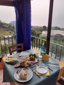 a table with a blue table cloth with food on it at agriturismo u zu peppino in Lipari
