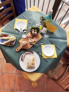 a green table with a plate of food on it at agriturismo u zu peppino in Lipari