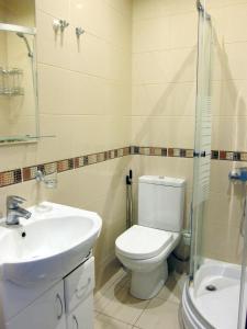 a bathroom with a toilet and a sink and a shower at Apartments in the Center of Batumi in Batumi +7 photos