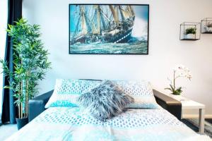 a bedroom with a bed with a ship painting on the wall at 100 Walk Score Unlimited Wifi Netflix Immaculate in Perth