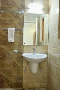 a bathroom with a sink and a mirror at The Fern Villas Nainital By Beyond Stay in Nainital