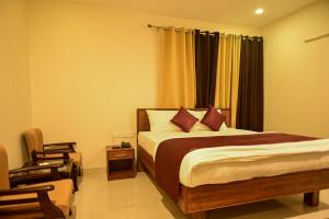 a bedroom with a bed and a chair at The Fern Villas Nainital By Beyond Stay in Nainital