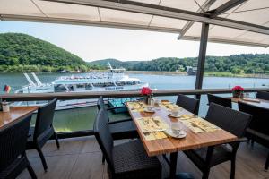 a dining room with a boat in the water at Garni Hotel Henn in Simmerath
