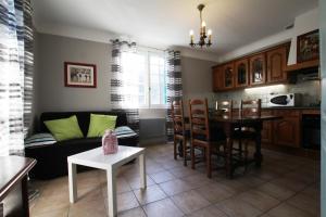 a living room with a couch and a table at Gite Moulin Urketa in Ayherre