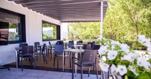 a restaurant with tables and chairs on a deck at Hostal Restaurante Cuatro Caminos in Cubillos del Sil