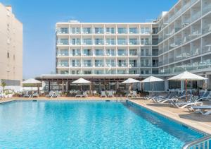 a swimming pool in front of a large building at Alua Leo in Can Pastilla