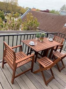 a wooden table and two chairs on a deck at Ferienwohnung Greta in Norden