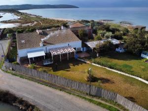 an aerial view of a house with a fence at Antica Peschiera Porto Botte in Porto Botte