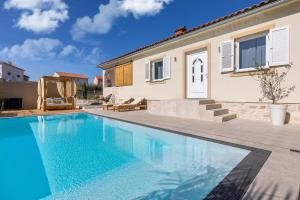 a swimming pool in front of a house at Villa Luna in Županje