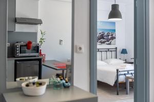 科斯镇Milva Apartments的一间带床的房间和带微波炉的厨房