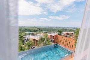 een uitzicht op een zwembad vanuit een huis bij Sky View Luxury Pool Villa - SHA in Suratthani